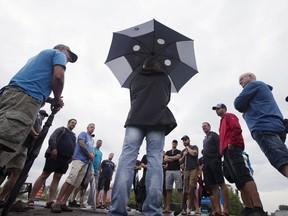 Clement Masse, head of the Steelworkers Local 9700 union, center, speaks to locked-out employees outside the Aluminerie de Becancour Inc. (ABI) aluminum plant in Becancour, Quebec, in August 2018.