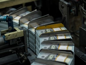 Stacks of money move through a printing machine in Texas.