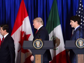 Prime Minister Justin Trudeau participates in a signing ceremony for the new United States-Mexico-Canada Agreement with President of the United States Donald Trump and President of Mexico Enrique Pena Nieto in Buenos Aires, Argentina on Friday, Nov. 30, 2018. The U.S. House of Representatives began its summer break today leaving the ratification of the new North American trade deal hanging, rekindling angst that a frustrated President Donald Trump will blow up the existing pact.