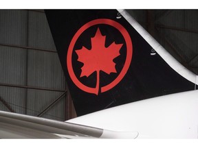 The tail of an Air Canada aircraft is seen at a hangar at the Toronto Pearson International Airport in Mississauga, Ont., on February 9, 2017. Nearly three dozen passengers sustained minor injuries Thursday when an Air Canada flight travelling from Toronto to Sydney, Australia, ran into severe turbulence, prompting an emergency landing in Honolulu.