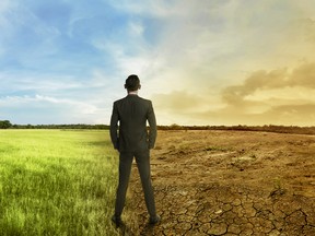 Asian businessman standing between different climate