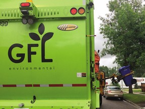 A Green for Life Environmental Corporation (GFL) garbage truck collects garbage and green bins in Toronto.