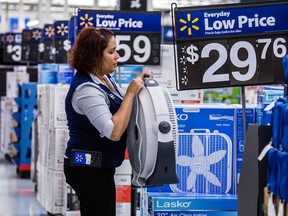 An employee arranges products on display at a Walmart Inc. store in Secaucus, New Jersey.