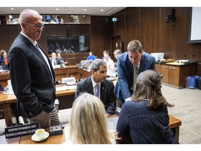 Conservative MPs Glen Motz, left, Pierre Paul-Hus, left, and Alupa Clarke speak to staff before the Standing Committee on Public Safety and National Security to discuss their request for a study of the Desjardins Group Data Breach, in Ottawa on Monday, July 15, 2019.