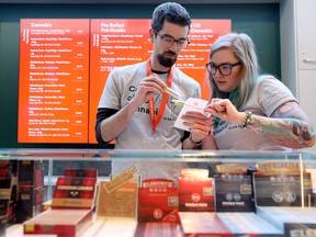 Employees at the Fire and Flower store in Ottawa prepare an order for a customer. Ontario is to get 50 more cannabis retail stores in October.