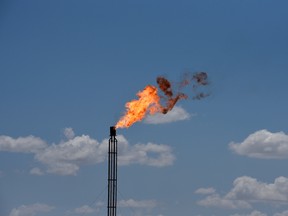 A flare burns off excess gas from a gas plant in the Permian Basin oil production area near Wink, Texas.