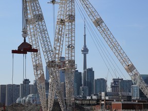 The downtown skyline and CN Tower are seen past cranes in the waterfront area envisioned by Alphabet Inc's Sidewalk Labs as a new technical hub in the Port Lands district of Toronto.