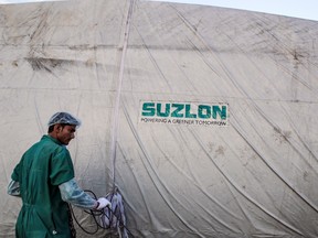 The Suzlon Energy Ltd. logo is displayed on a wind turbine blade cover at the company's rotor blade manufacturing plant in Bhuj, India.
