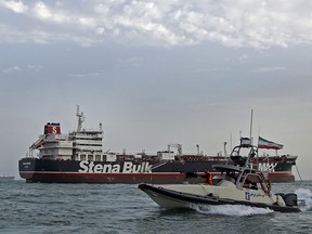 This photo taken Sunday show Iranian Revolutionary Guards patrolling around the British-flagged tanker Stena Impero as it's anchored off the Iranian port city of Bandar Abbas.