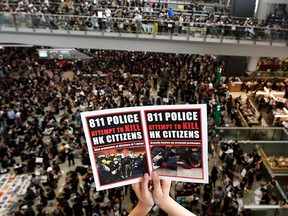 Pro-democracy protesters gather against the police brutality and the controversial extradition bill at Hong Kong's international airport on August 12, 2019. - Hong Kong airport authorities cancelled all remaining departing and arriving flights at the major travel hub on August 12, after thousands of protesters entered the arrivals hall to stage a demonstration.