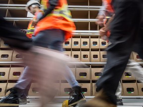 People walk past a sorting area at Amazon's new fulfillment centre in Caledon, Ont.