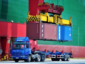 Containers are transferred at a port in Qingdao in China's eastern Shandong province.