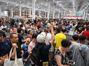 People visit the first Costco outlet in China on the store's opening day in Shanghai on August 27, 2019.