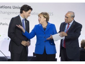 Canadian Prime Minister Justin Trudeau speaks with German Chancellor Angela Merkel and OECD Secretary General Angel Gurria at the start of a session on carbon pricing at the United Nations climate change summit, Monday November 30, 2015 in Le Bourget, France. An international review of Canada's economic immigration system says the country is doing well when it comes to how it selects and welcomes foreign workers.THE CANADIAN PRESS/Adrian Wyld