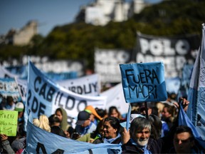Demonstrators march against the economic policies of the government of Argentine President Mauricio Macri in Buenos Aires, on Aug. 22, 2019.