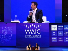 Elon Musk (R), co-founder and CEO of Tesla, and Jack Ma, co-chair of the UN High-Level Panel on Digital Cooperation, speak onstage during the the World Artificial Intelligence Conference (WAIC) in Shanghai on August 29, 2019.