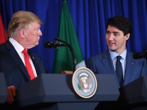 U.S. President Donald Trump (L) and Canadian Prime Minister Justin Trudeau along with Mexico's President Enrique Pena Nieto (out of frame), deliver a statement on the signing of a new free trade agreement in Buenos Aires, on November 30, 2018, on the sidelines of the G20 Leaders' Summit.