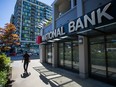 A pedestrian passes in front of a National Bank of Canada branch in Richmond, British Columbia, Canada, on Monday, Aug. 28, 2017.