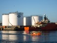 The Grampian Contender, a standby safety vessel, right, moves past oil storage silos operated by Caledonian Oil Ltd. on the quay-side at Aberdeen Harbour, Scotland, on Tuesday, Dec. 8, 2015.