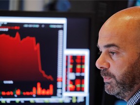 A trader works on the floor of the New York Stock Exchange shortly after the closing bell in New York, U.S., August 23, 2019.