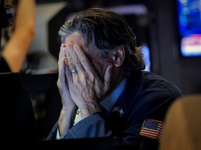 A trader reacts on the floor of the New York Stock Exchange.