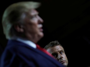 French President Emmanuel Macron looks on as U.S. President Donald Trump speaks during a news conference at the end of the G7 summit in Biarritz, France on Monday.