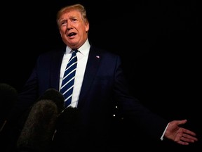 U.S. President Donald Trump gestures as he speaks to the press on August 23, 2019.