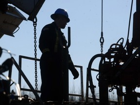 A oilfield worker toils on a Bonterra rig near the town of Drayton valley.