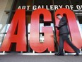 A pedestrian walks by the Art Gallery of Ontario in Toronto.