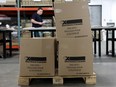 worker prepares materials at the Elections Canada distribution centre in advance of the upcoming federal election, in Ottawa.