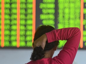 A investor monitors stock prices at a securities company in Hangzhou in China's eastern Zhejiang province.