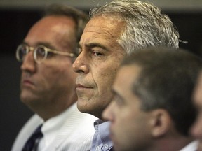 U.S. financier Jeffrey Epstein, centre appears in court where he pleaded guilty to two prostitution charges in West Palm Beach, Florida, U.S. July 30, 2008.