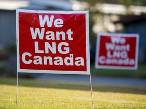 Signs reading "We Want LNG Canada" stand on a lawn in Kitimat, British Columbia, in 2016.