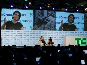 Adam Neumann, left, CEO of WeWork, speaks to guests during the TechCrunch Disrupt event in Manhattan, in New York City, in 2017.