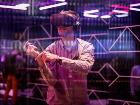 In this file photo taken on April 30, 2019 An attendee tries out the new Oculus Quest Virtual Reality (VR) gaming system at the Facebook F8 Conference at McEnery Convention Center in San Jose, California.