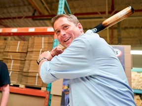 Conservative leader Andrew Scheer holds a maple baseball bat during a campaign stop at KR3 Bats in Cambridge, Ontario on Sept. 24, 2019.