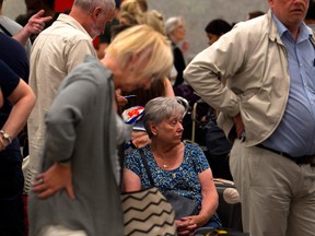 Passengers of British travel group Thomas Cook queue at Son Sant Joan airport in Palma de Mallorca on Monday. - British travel group Thomas Cook declared bankruptcy after failing to reach a last-ditch rescue deal, triggering the UK's biggest repatriation since World War II to bring back stranded passengers.