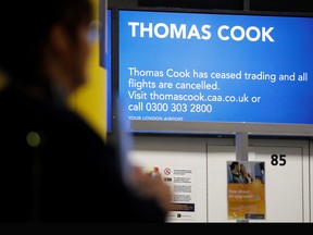 Passengers walk past the closed Thomas Cook check-in desks at the South Terminal of London Gatwick Airport in Crawley, south of London on September 23, 2019, after the company announced it was taking steps to enter into compulsory liquidation with immediate effect.