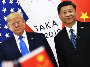 In this file photo taken on June 29, 2019 Chinese President Xi Jinping, right, and U.S. President Donald Trump attend their bilateral meeting on the sidelines of the G20 Summit in Osaka, Japan.