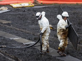 Workers clean up an oil spill at BP Plc's Prudhoe Bay oil fields in Alaska, in 2006. The oil giant sold its assets in Alaska after 60 years in the state in August.