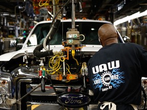 A worker assembles a Ford pickup truck at a plant in Louisville, Kentucky.