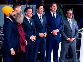 Federal party leaders, NDP leader Jagmeet Singh, Green Party leader Elizabeth May, People's Party of Canada leader Maxime Bernier, host Patrice Roy from Radio-Canada, Prime Minister and Liberal leader Justin Trudeau, Conservative leader Andrew Scheer, and Bloc Quebecois leader Yves-Francois Blanchet pose for pictures before the Federal leaders French language debate at the Canadian Museum of History in Gatineau, Quebec on October 10, 2019.
