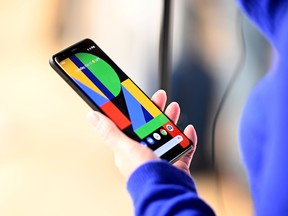 A woman holds the Google Pixel 4 phone during a Google product launch event.