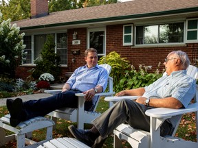 Andrew Scheer, left, speaks with Dennis Matthews, 76, as he campaigns for the upcoming election in London, Ont., on Sept. 24, 2019.