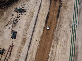 A truck drives on a road at the Suncor Energy Inc. Millennium mine in this aerial photograph taken above the Athabasca oil sands near Fort McMurray, Alberta.