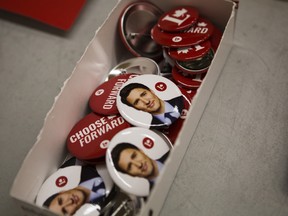 Buttons depicting the face of Prime Minister Justin Trudeau sit in a boc at a booth for Liberal candidate Majid Jowhari at an all-candidates debate at the Langstaff Community Centre in Richmond Hill, Ontario, Canada, on Tuesday, Oct. 1, 2019.