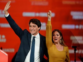 Liberal leader and Canadian Prime Minister Justin Trudeau and his wife Sophie Gregoire Trudeau wave to supporters after the federal election at the Palais des Congres in Montreal, Oct. 22, 2019.