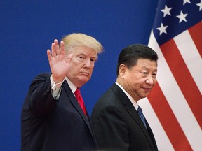 This file picture taken on November 9, 2017 shows U.S. President Donald Trump, left, and China's President Xi Jinping leaving a business leaders event at the Great Hall of the People in Beijing.