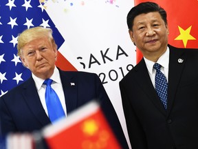 In this file photo taken on June 29, 2019 Chinese President Xi Jinping (R) and US President Donald Trump attend their bilateral meeting on the sidelines of the G20 Summit in Osaka, Japan.