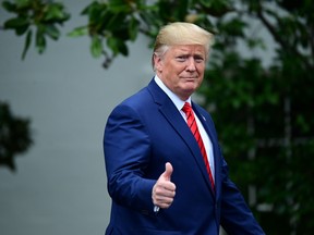 U.S. President Donald Trump gestures as he arrives for a photo opportunity with sheriffs from across the country on the South Lawn of the White House in Washington, U.S., September 26, 2019.